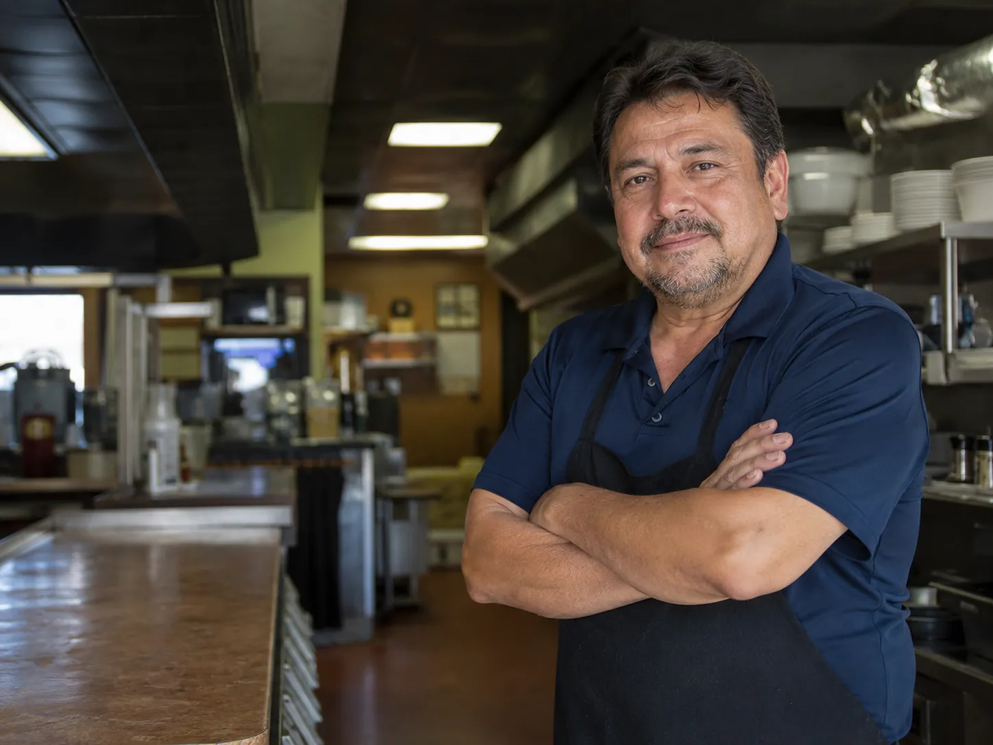 Family-owned restaurant owner inside a local kitchen