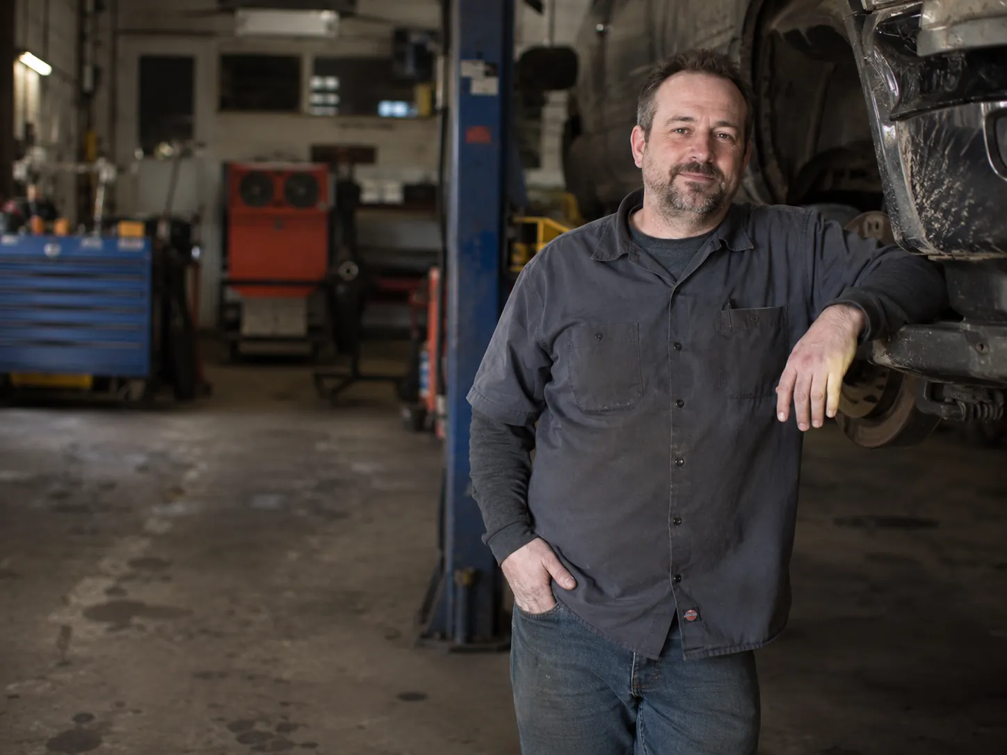 Independent auto shop owner inside a repair garage