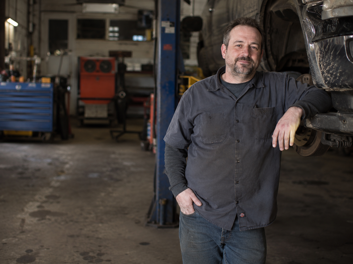 Independent auto shop owner inside a repair garage